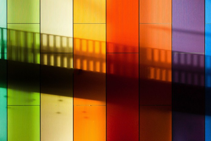 Shadow of a staircase on a rainbow striped wall